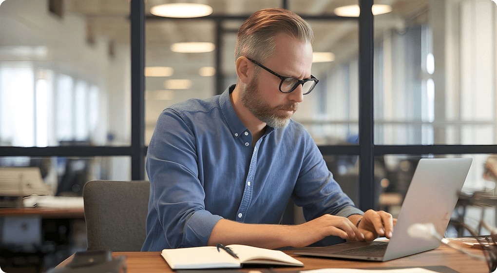 Professional working on a laptop in a modern office